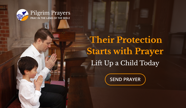 A parent and a child praying together in a Church