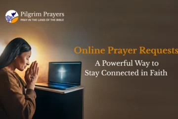 Person typing an online prayer request on a laptop with a Bible and cross nearby