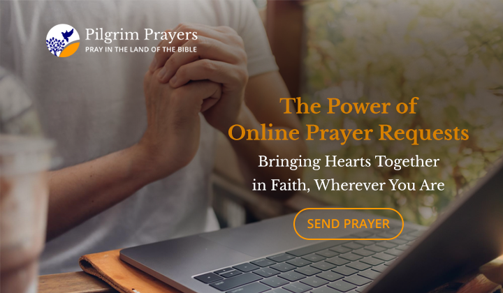 Person typing a prayer request on a laptop with a Bible and a candle beside them