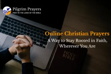 Person praying near a laptop with a Bible and a cross