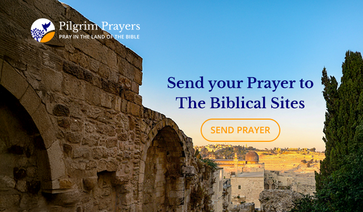 Sunrise over the Sea of Galilee with hands raised in prayer.