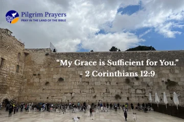 Bible verse from 2 Corinthians 12:9 with a peaceful view of the Western Wall in Jerusalem, symbolizing prayer and strength in weakness.