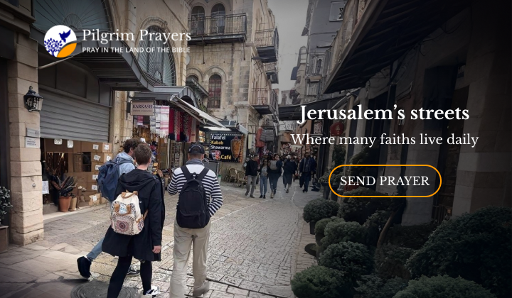 People walking through a busy street in Jerusalem’s Old City, with stone buildings, small shops, and cafés reflecting daily life returning after conflict.