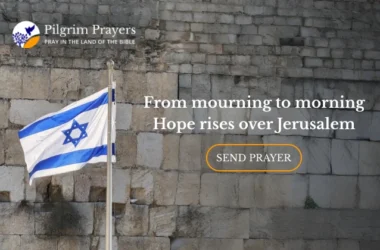 Israeli flag flying beside the Western Wall in Jerusalem, symbolizing remembrance, faith, and hope