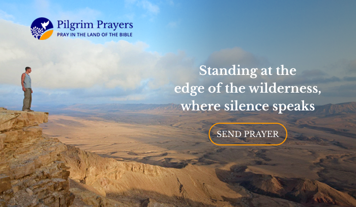 Man standing on cliff overlooking Judean desert landscape near Bethlehem