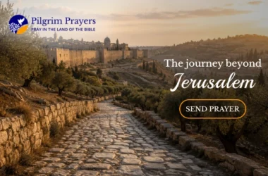 Ancient stone road leading east from Jerusalem toward the Mount of Olives and Bethany with olive trees and city walls visible in the morning light
